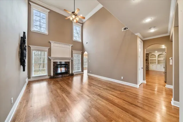 an empty room with windows and fan