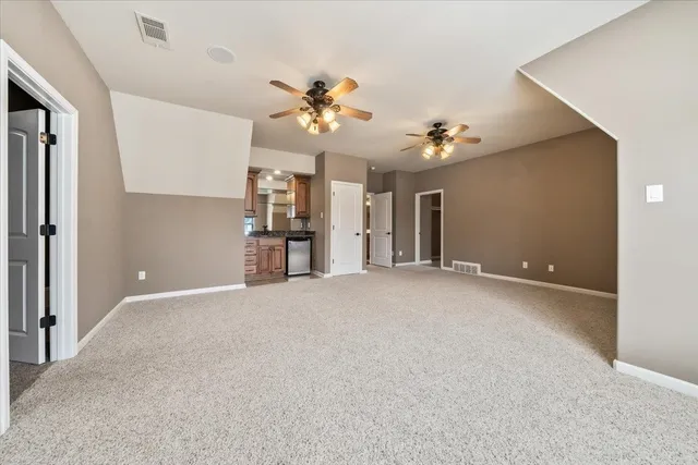 a kitchen with granite countertop a sink stainless steel appliances and cabinets