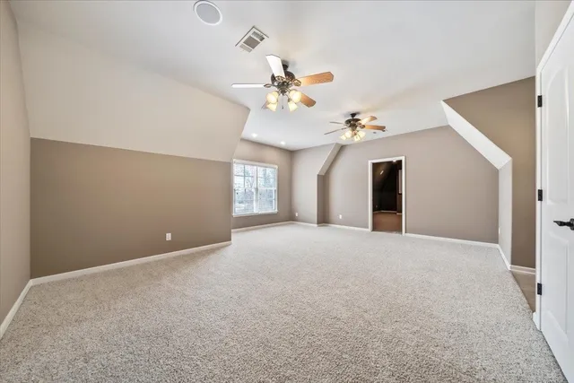 an empty room with a projector and fan