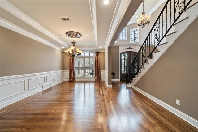 a view of entryway and hall with wooden floor