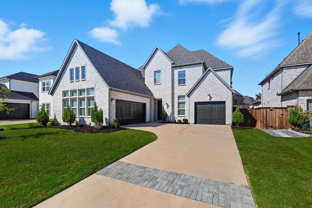 3630 Singer Lane Frisco, TX 75034 - Photo 1 of 1 French country home featuring driveway, roof with shingles, and brick siding
