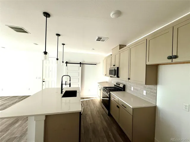 a kitchen with a sink stove and refrigerator