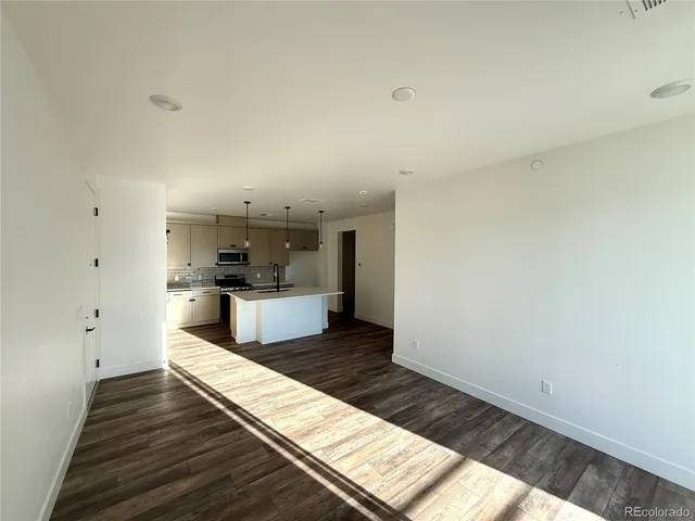 a view of a room with wooden floor and stairs