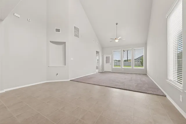 an empty room with windows and entrance