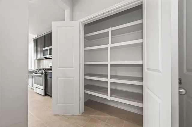 a living room with stainless steel appliances cabinets and a window