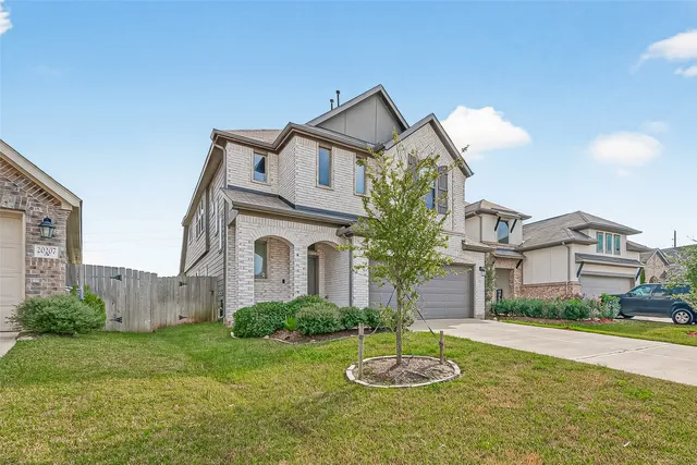 a front view of house with yard and outdoor seating