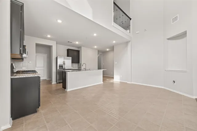 a view of kitchen with kitchen island refrigerator sink and stove