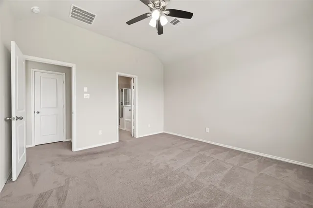 an empty room with chandelier fan