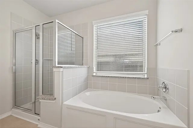 a white bath tub with a shower