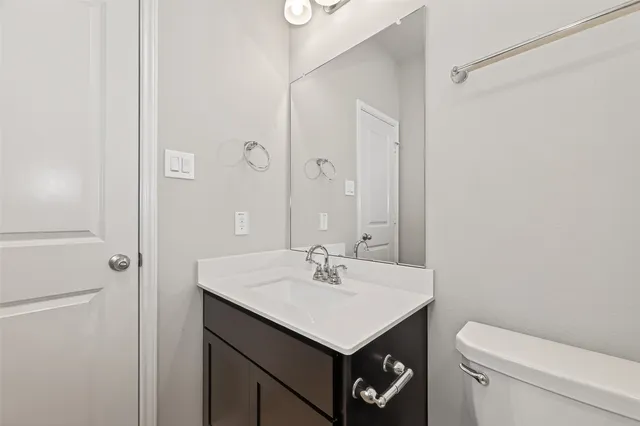 a bathroom with a sink toilet and vanity