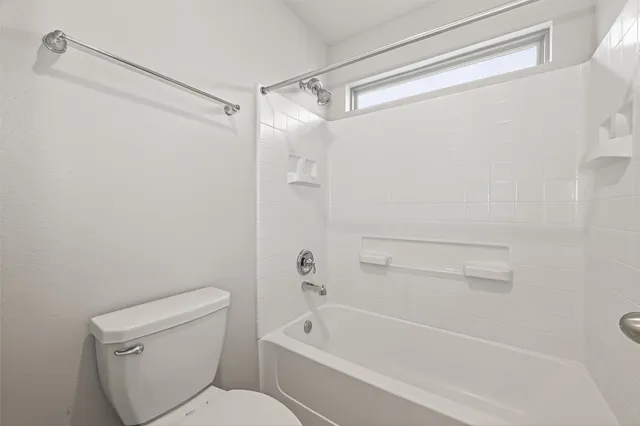 a bathroom with a toilet and a bathtub