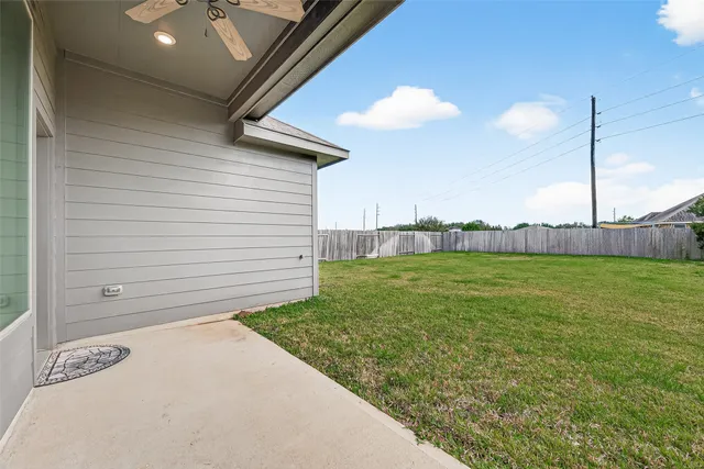 a view of a backyard with table and chairs