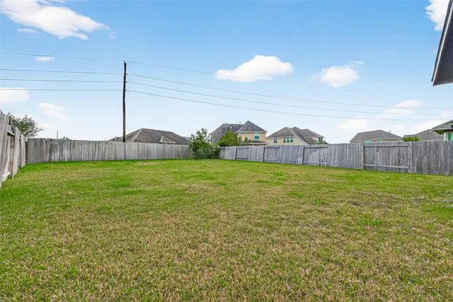 a view of a house with a yard and sitting space