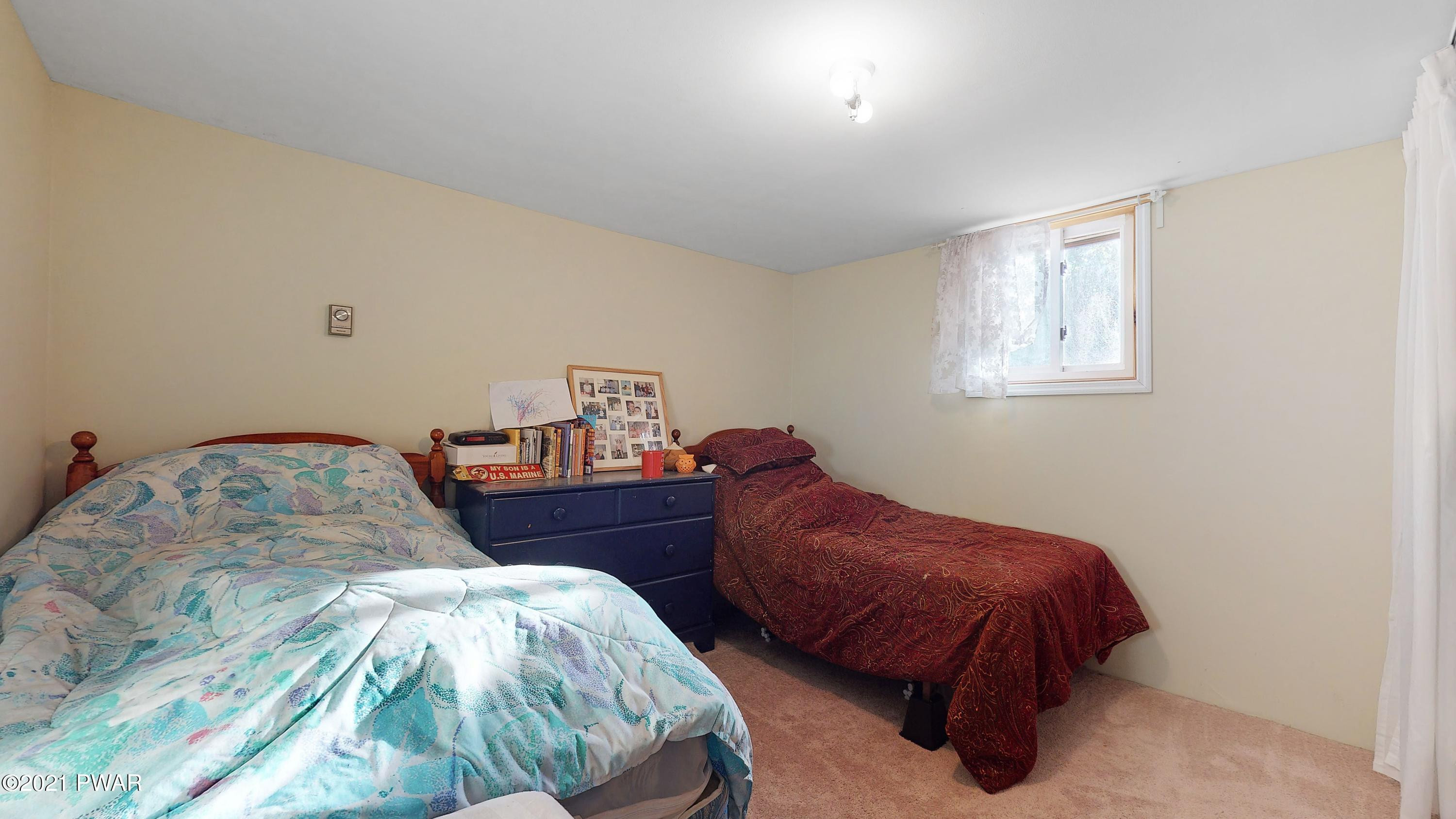 157 Roundhill Road Dingmans Ferry, PA 18328 - Photo 48 of 48 a bedroom with a bed and a lamp on dresser
