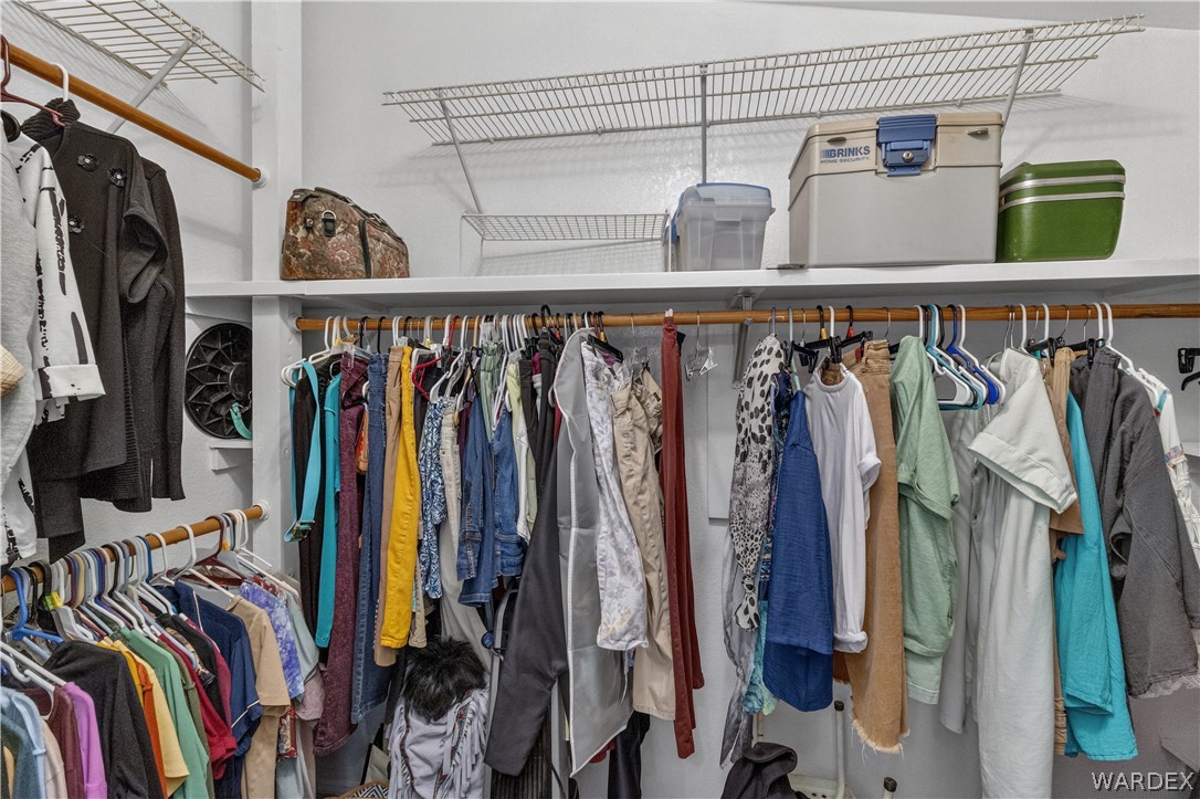 784 Pegasus Ranch Road Bullhead City, AZ 86429 - Photo 36 of 100 Integrated closet system featuring multiple hanging rods, wire shelving, and built-in shelving for comprehensive???????????????????????????????? storage