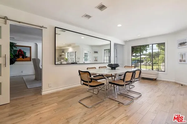 a dining room with furniture and wooden floor