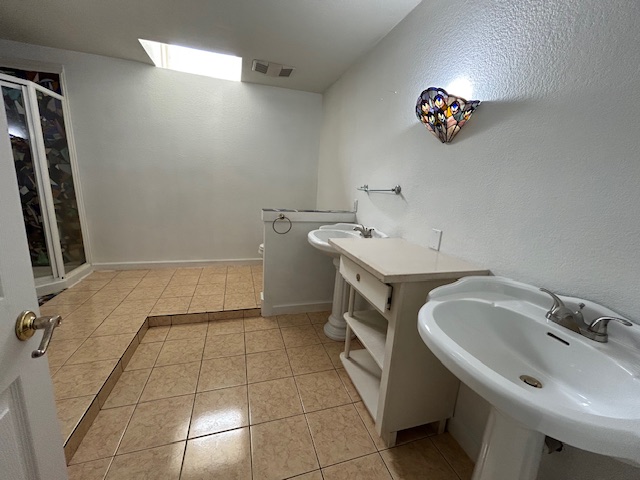109 North Main Street, Unit A Taylor, TX 76574 - Photo 12 of 17 a bathroom with a sink and a washing machine