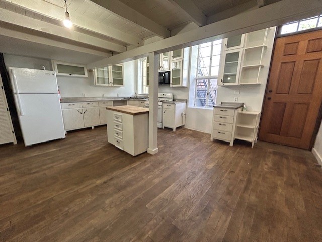 109 North Main Street, Unit A Taylor, TX 76574 - Photo 3 of 17 a kitchen with a refrigerator a stove top oven and a wooden floor