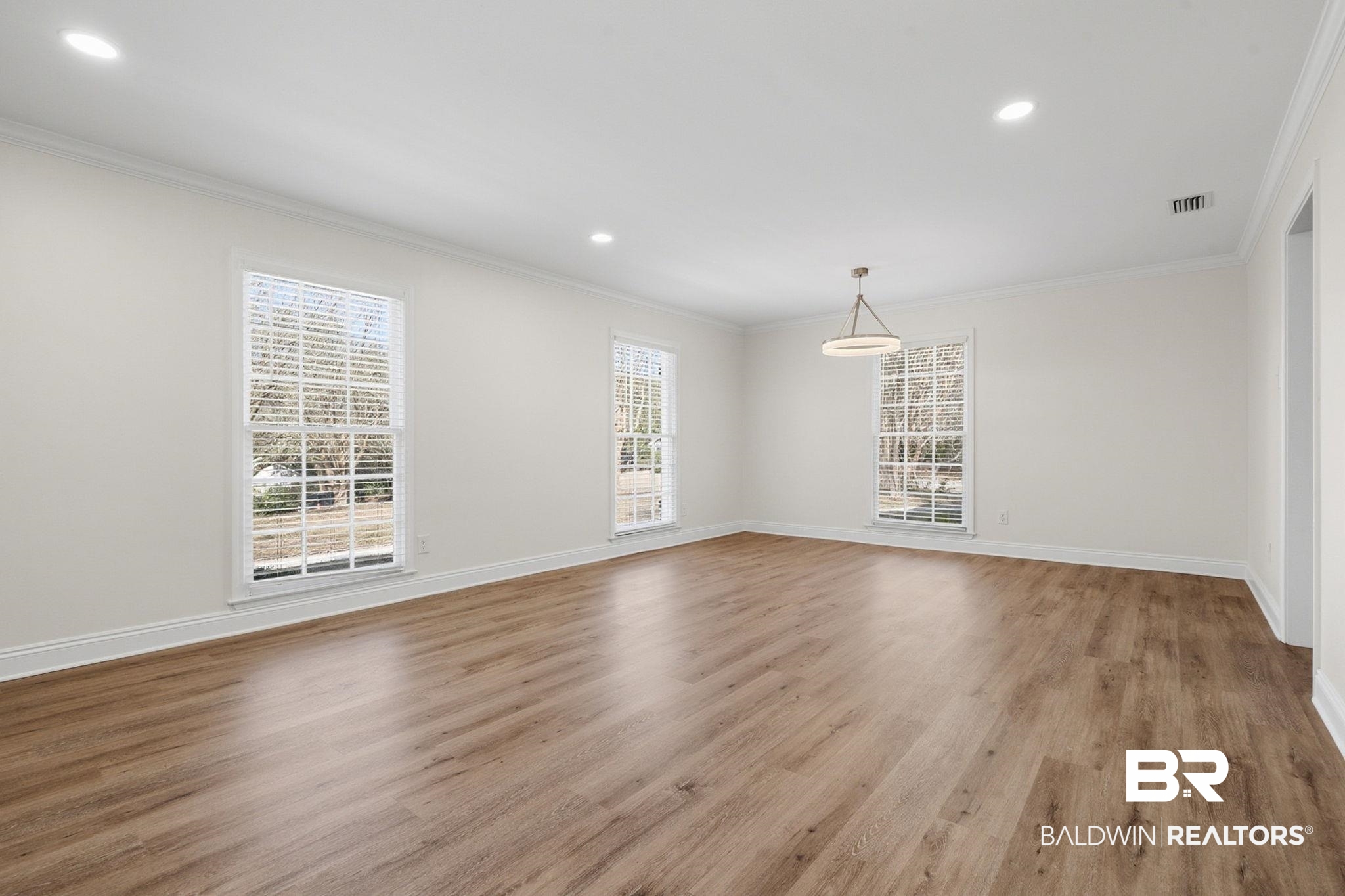 814 Nassau Drive Mobile, AL 36608 - Photo 13 of 44 Empty room featuring light wood finished floors, recessed lighting, and crown molding
