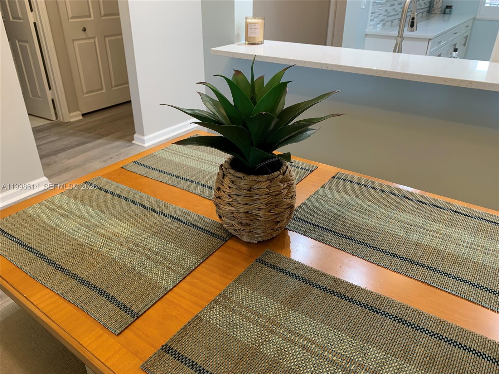 6082 Southeast Landing Way, Unit 10 Stuart, FL 34997 - Photo 11 of 35 a view of a potted plant with a bench