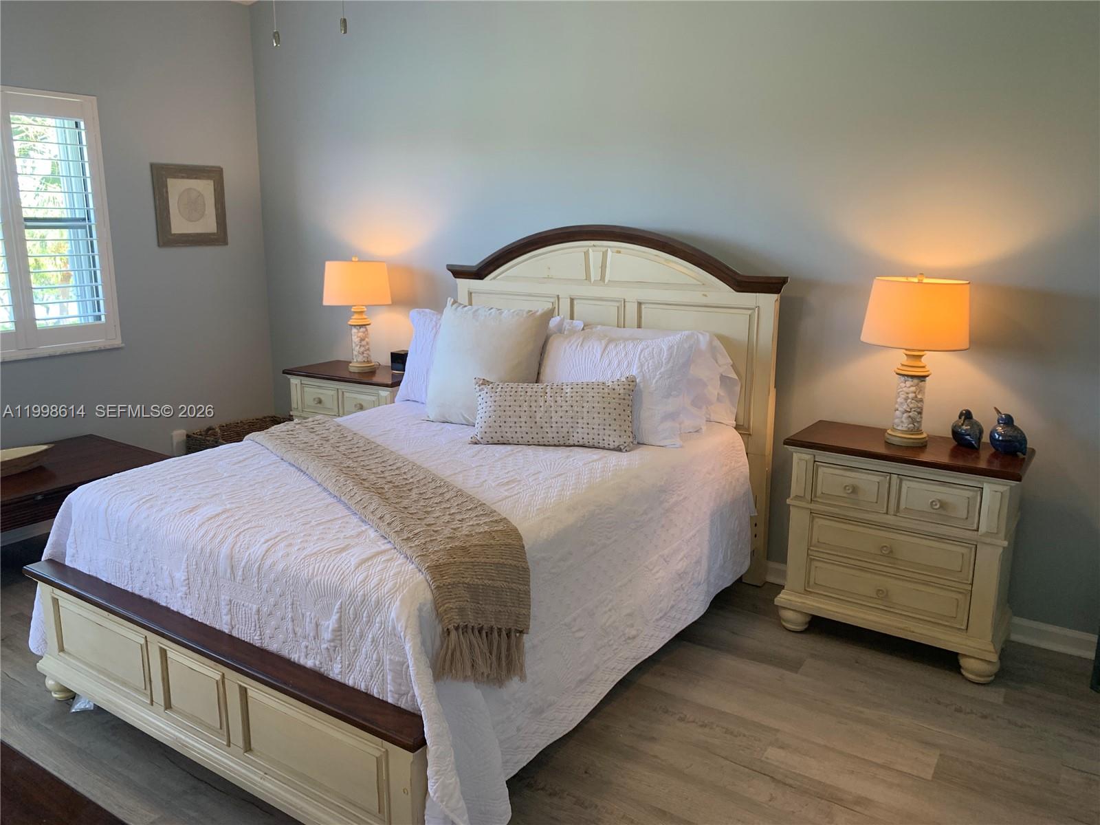 6082 Southeast Landing Way, Unit 10 Stuart, FL 34997 - Photo 17 of 35 a bedroom with a bed and a window
