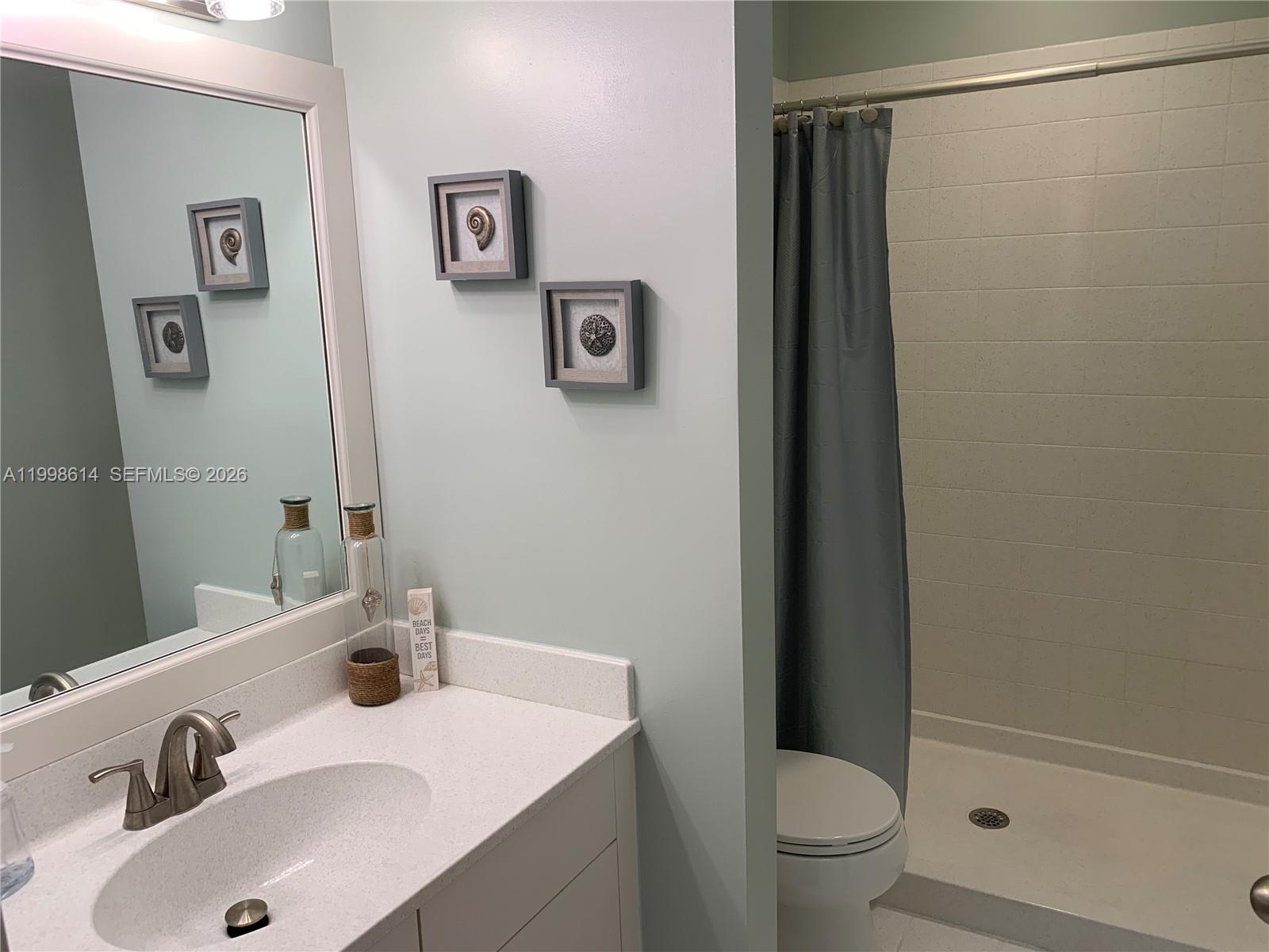 6082 Southeast Landing Way, Unit 10 Stuart, FL 34997 - Photo 19 of 35 a bathroom with a sink toilet and vanity