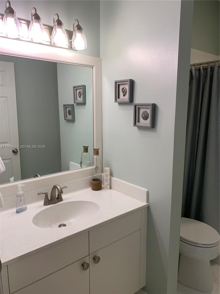 6082 Southeast Landing Way, Unit 10 Stuart, FL 34997 - Photo 20 of 35 a bathroom with a sink and a mirror