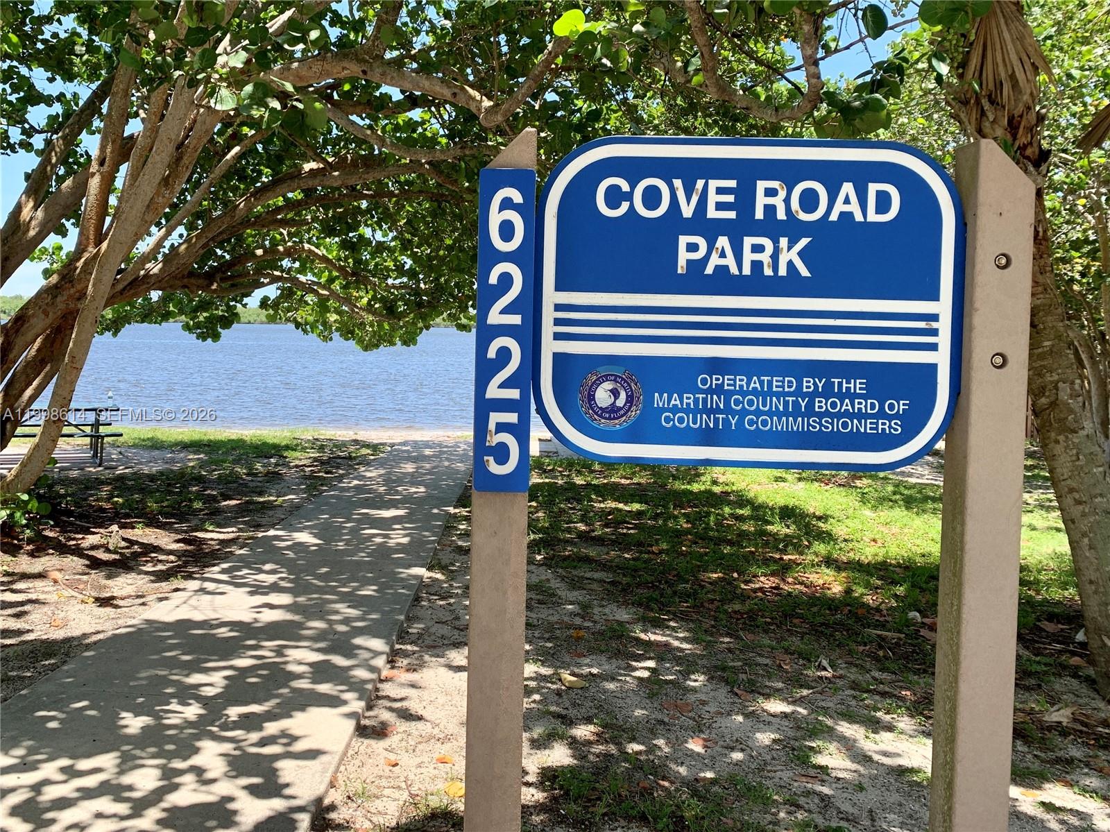 6082 Southeast Landing Way, Unit 10 Stuart, FL 34997 - Photo 32 of 35 a sign on a pole on a street