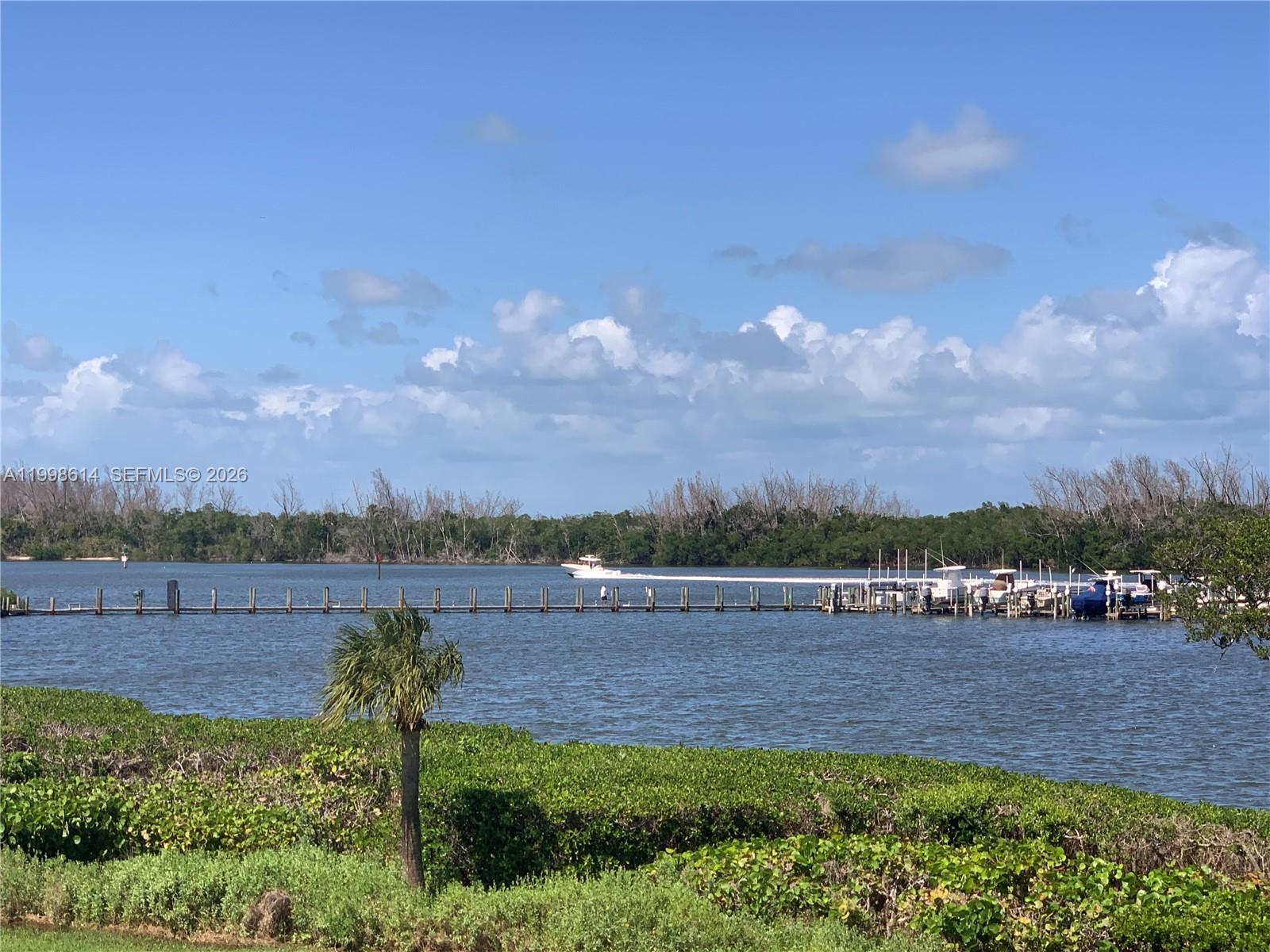 6082 Southeast Landing Way, Unit 10 Stuart, FL 34997 - Photo 35 of 35 a view of lake with mountain in background