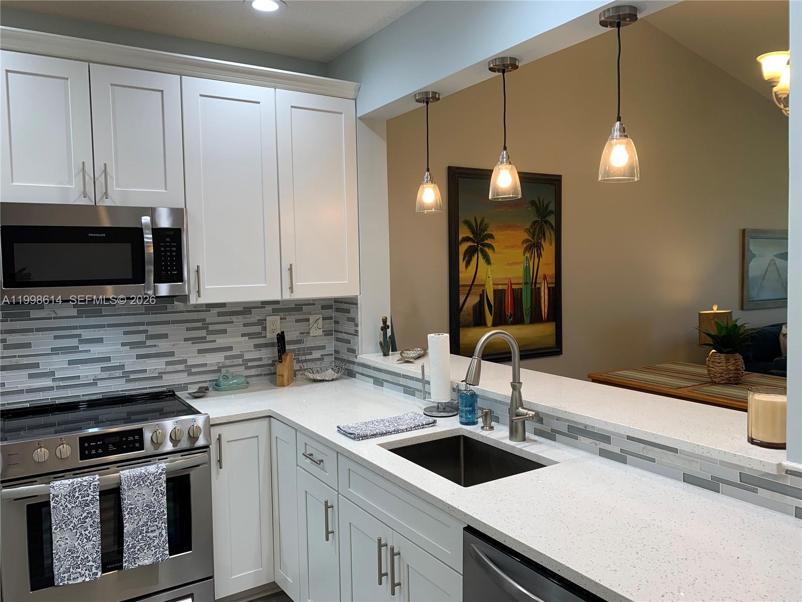 6082 Southeast Landing Way, Unit 10 Stuart, FL 34997 - Photo 9 of 35 a kitchen with a sink and a stove top oven