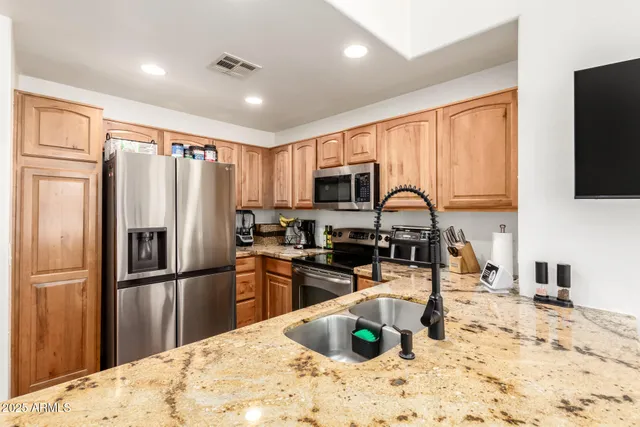 a kitchen that has a sink and a stove top oven
