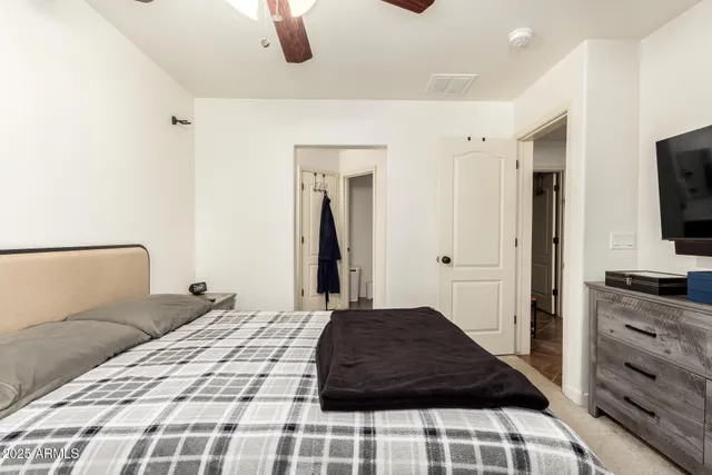 a bedroom with a bed and a flat screen tv