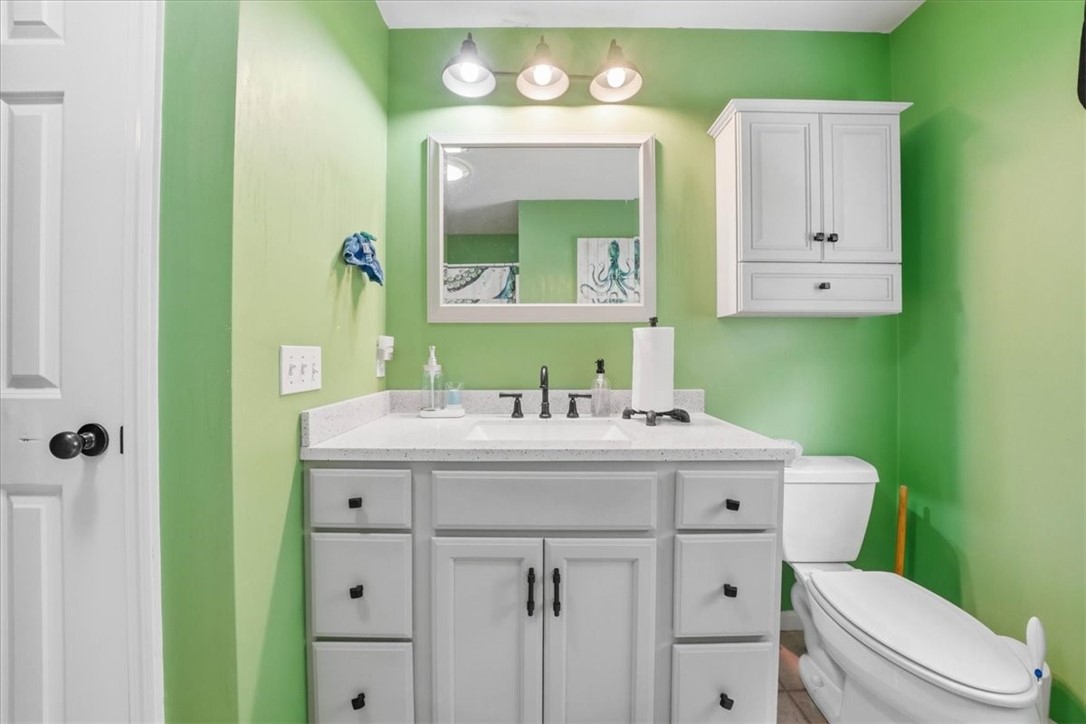 26 Davis Circle Warwick, RI 02886 - Photo 26 of 50 Spacious updated vanity, contemporary finishes, tile flooring, plentiful cabinet space, a convenient linen closet, and a bright window that fills the room with natural light.