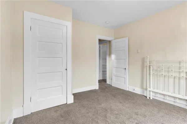 an empty room with closet area