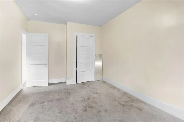 an empty room with closet area