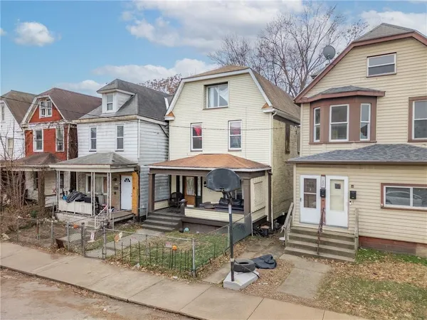 a front view of a residential apartment building with a yard