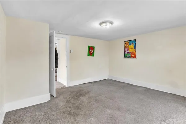 an empty room with a painting on the wall