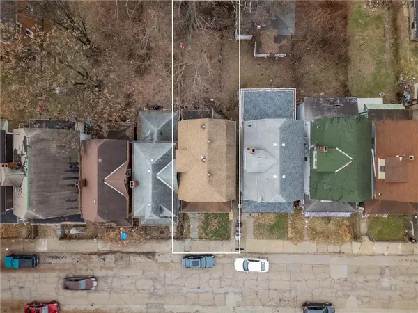 an aerial view of residential houses with outdoor space