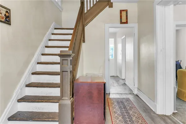 a view of a hallway with wooden floor and entryway