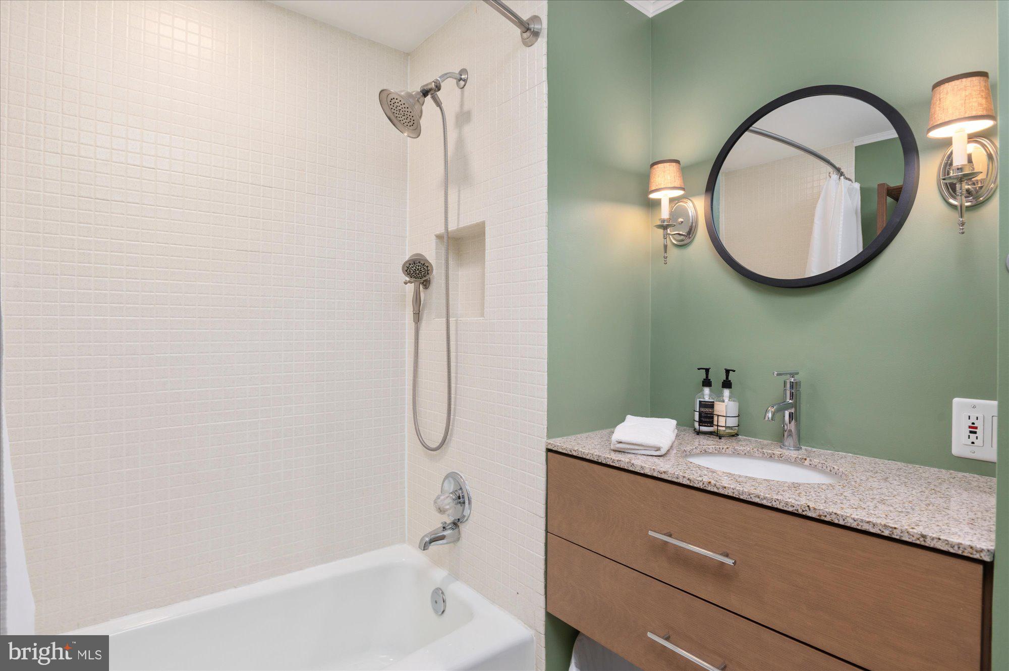 2230 California Street Northwest, Unit 4DW Washington, DC 20008 - Photo 22 of 43 a bathroom with a granite countertop sink mirror and vanity