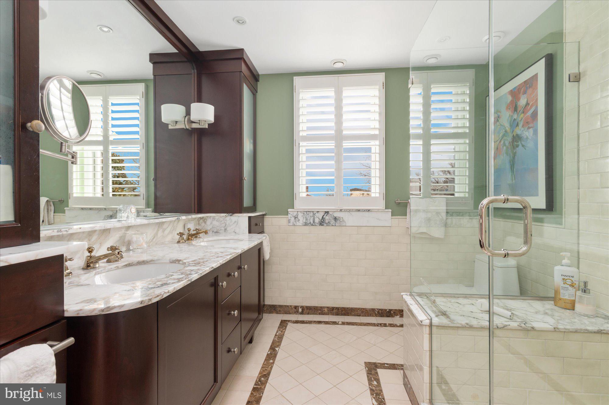 2230 California Street Northwest, Unit 4DW Washington, DC 20008 - Photo 26 of 43 a bathroom with a granite countertop sink and a mirror