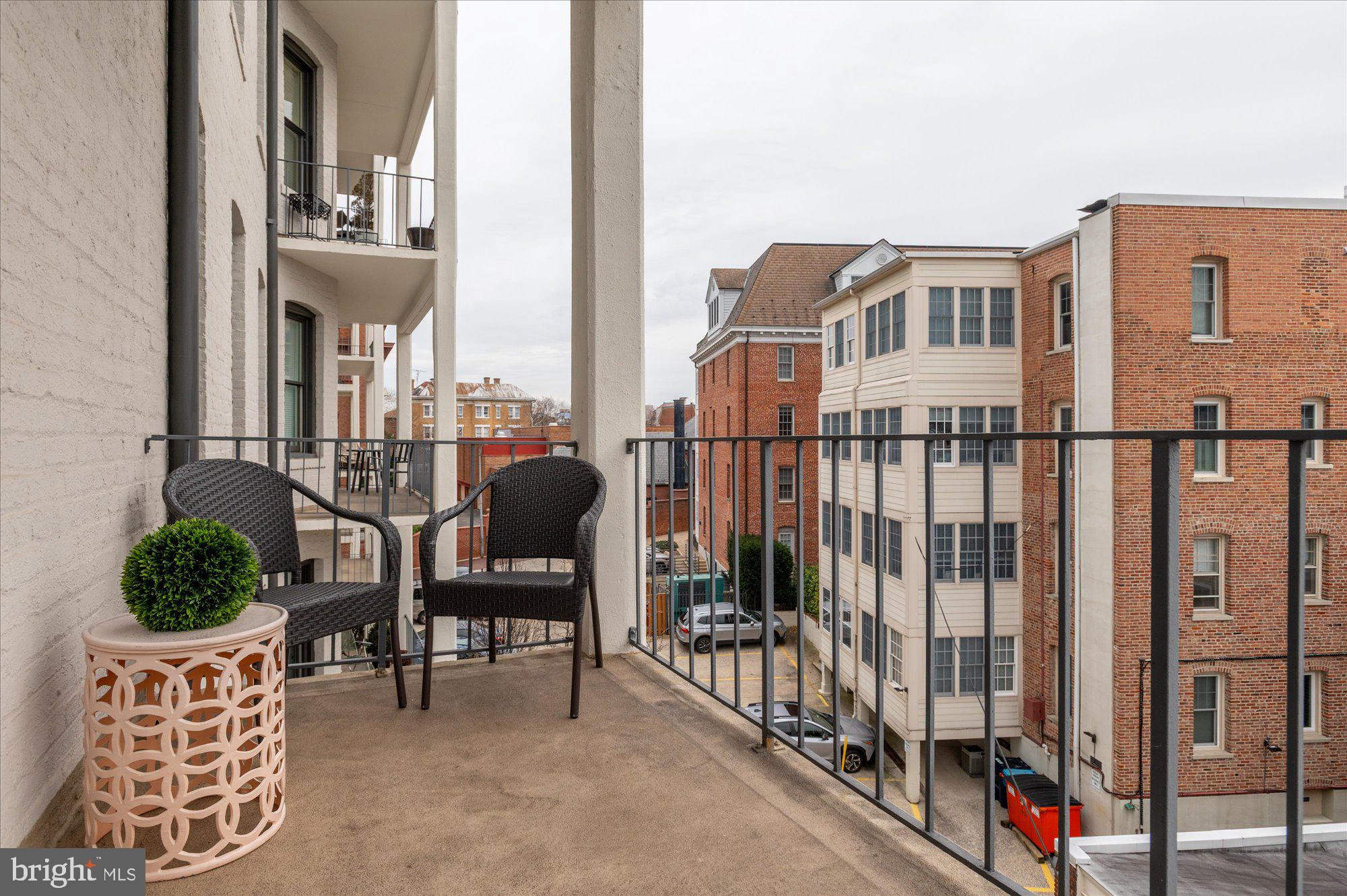 2230 California Street Northwest, Unit 4DW Washington, DC 20008 - Photo 28 of 43 a view of a balcony with chairs and a potted plant