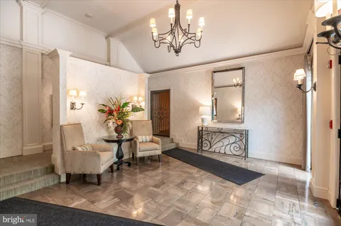 a living room with furniture and a chandelier