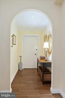 a view of a room that has a bench and a table in it