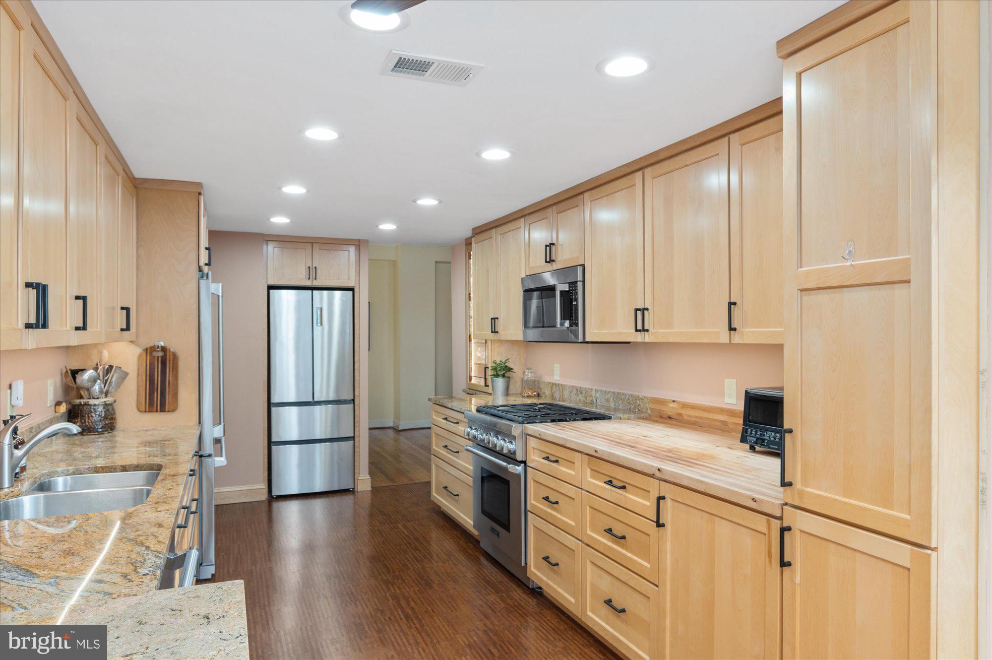 2230 California Street Northwest, Unit 4DW Washington, DC 20008 - Photo 10 of 43 a kitchen with stainless steel appliances granite countertop a refrigerator sink and cabinets