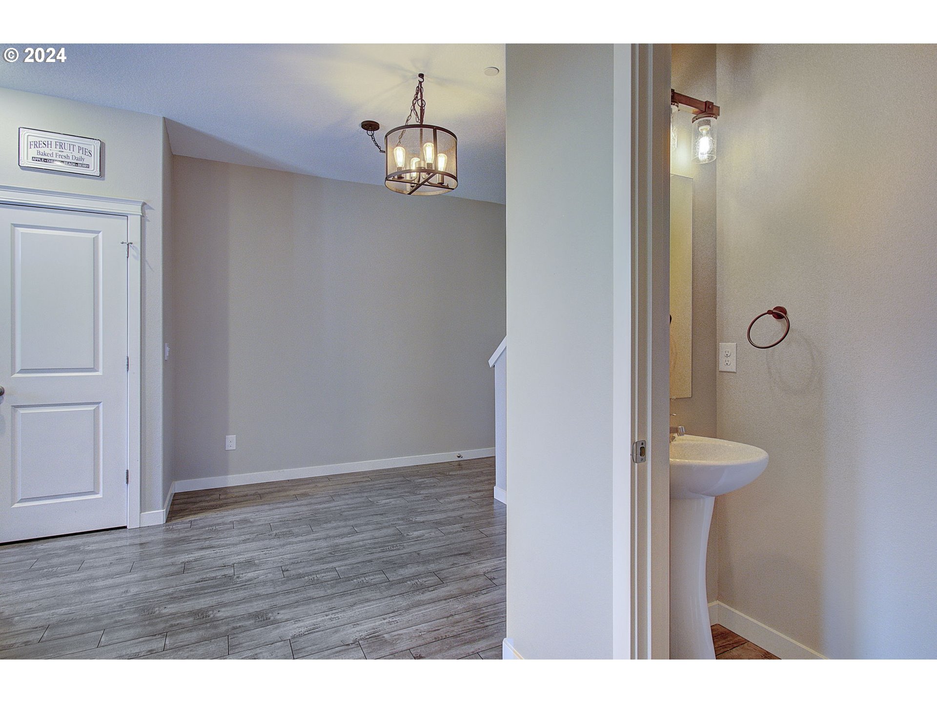 146 North 44th Place Ridgefield, WA 98642 - Photo 12 of 30 a view of an empty room with wooden floor and a bathroom