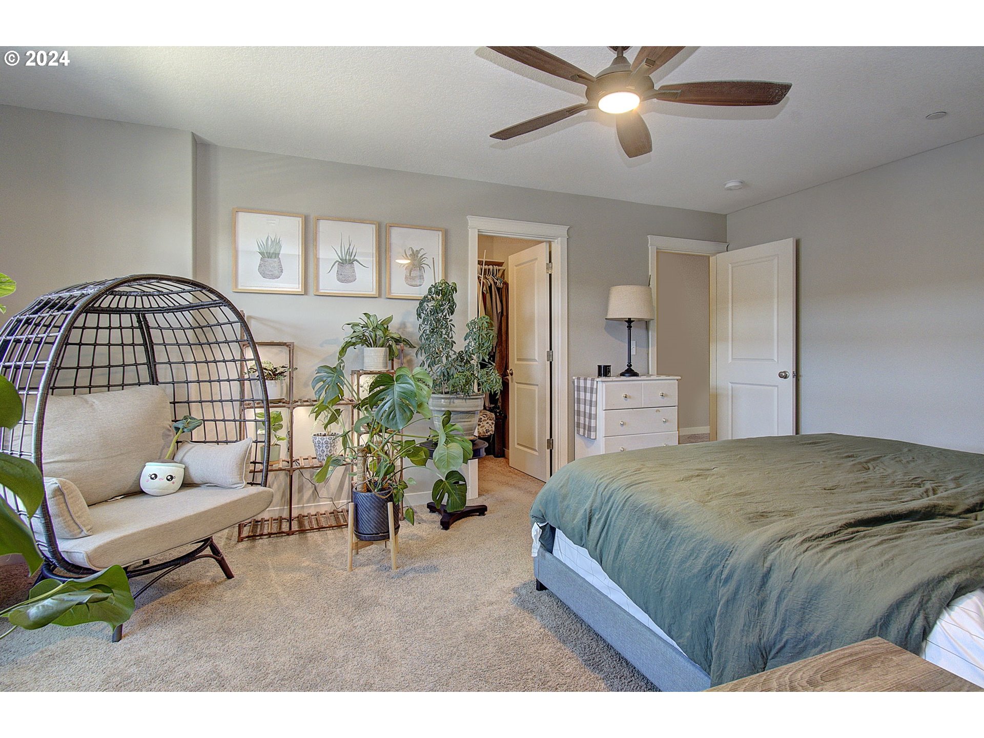 146 North 44th Place Ridgefield, WA 98642 - Photo 25 of 30 a spacious bedroom with a bed a couch and a chandelier