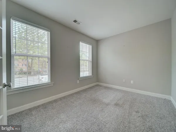 a view of a room with wooden floor and a ceiling fan