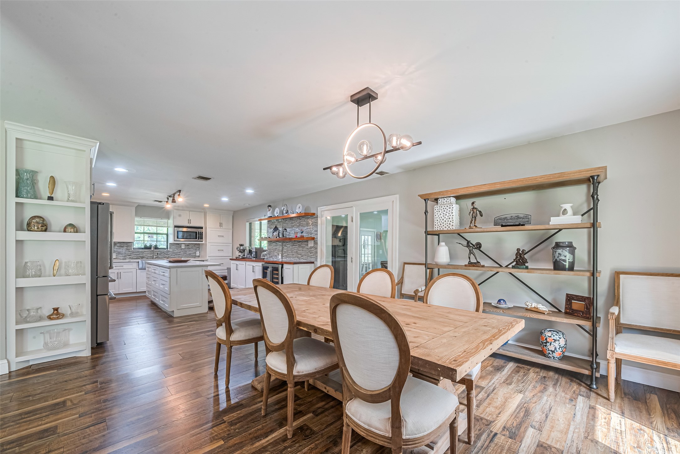 24314 Anderson Street Huffman, TX 77336 - Photo 15 of 48 a view of a dining room with furniture a chandelier and wooden floor