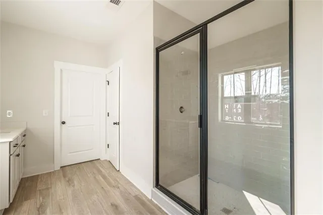 a view of hallway with a large window and wooden floor
